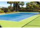 Well-maintained tennis court featuring a vibrant blue surface and green surround at 736 Island Way # 606, Clearwater Beach, FL 33767