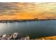 Scenic water view featuring a vibrant sunset, coastal homes, and boats docked along the tranquil waterfront at 736 Island Way # 606, Clearwater Beach, FL 33767