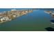 Expansive waterfront view showcasing tranquil water, lush landscaping, and upscale homes along the coast at 736 Island Way # 606, Clearwater Beach, FL 33767