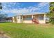 House back view with screened porch and yard at 924 Bunker View Dr, Apollo Beach, FL 33572