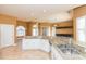 Modern kitchen with white cabinets, granite counters, and stainless steel appliances at 924 Bunker View Dr, Apollo Beach, FL 33572