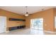 Living room with tile floors, built-ins, and sliding glass doors at 924 Bunker View Dr, Apollo Beach, FL 33572