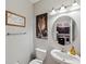 Powder room with pedestal sink, granite countertop, and decorative art at 9928 Ivory Dr, Ruskin, FL 33573