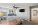 Primary bedroom with a ceiling fan, large windows, and access to the hallway at 9928 Ivory Dr, Ruskin, FL 33573