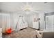 Charming Bedroom with a crib, chandelier, and plenty of natural light at 9928 Ivory Dr, Ruskin, FL 33573