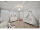 Bright Bedroom features a crib, dresser, and plush seating at 9928 Ivory Dr, Ruskin, FL 33573