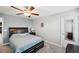 Comfortable bedroom with large bed and full-length mirror at 9928 Ivory Dr, Ruskin, FL 33573