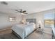 Serene bedroom with a ceiling fan and large window offering natural light at 9928 Ivory Dr, Ruskin, FL 33573