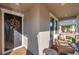 Inviting front porch with seating and a charming autumnal wreath at 9928 Ivory Dr, Ruskin, FL 33573