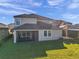 Two story house with screened patio and backyard at 9928 Ivory Dr, Ruskin, FL 33573
