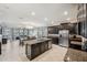 Spacious kitchen with dark cabinetry, granite counters, and stainless steel appliances at 9928 Ivory Dr, Ruskin, FL 33573