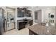 Modern kitchen with dark wood cabinets, granite counters, and stainless steel appliances at 9928 Ivory Dr, Ruskin, FL 33573