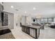 Open-concept kitchen with island, dark cabinets, and granite countertops at 9928 Ivory Dr, Ruskin, FL 33573