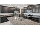 Modern kitchen with dark cabinets, granite countertops, and stainless steel appliances at 9928 Ivory Dr, Ruskin, FL 33573