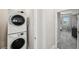 Stackable washer and dryer in laundry room with access to hallway at 9928 Ivory Dr, Ruskin, FL 33573