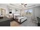 Main bedroom with ceiling fan, large windows, and plush carpet at 9928 Ivory Dr, Ruskin, FL 33573