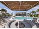 Curved seating area with shade structure overlooking pool at 12404 52Th E St, Parrish, FL 34219