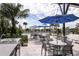 Pool area with patio tables, umbrellas, and grill at 12404 52Th E St, Parrish, FL 34219
