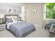 Cozy bedroom with a neutral color palette, plush bedding and large window at 12458 49Th E St, Parrish, FL 34219
