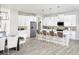 Modern kitchen with island, stainless steel appliances, and white cabinetry at 12458 49Th E St, Parrish, FL 34219