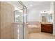 Large bathroom with a walk-in shower, soaking tub, and vanity at 18052 Java Isle Dr, Tampa, FL 33647