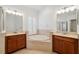 Bathroom with double vanities, soaking tub, and a separate shower at 18052 Java Isle Dr, Tampa, FL 33647