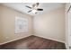 Bedroom featuring wood floors and a window with plantation shutters at 18052 Java Isle Dr, Tampa, FL 33647