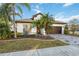 Front view of a house with a landscaped yard at 18052 Java Isle Dr, Tampa, FL 33647