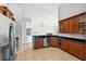 Modern kitchen with stainless steel appliances and wood cabinets at 18052 Java Isle Dr, Tampa, FL 33647