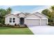 Attractive single-story house with three-car garage and landscaped front yard at 6856 Daintree Ct, Land O Lakes, FL 34638
