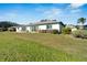 Home's backyard boasts a spacious grassy area and patio at 2407 Locksley St # 224, Sun City Center, FL 33573