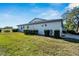 Home's backyard features a grassy area and well-manicured shrubs at 2407 Locksley St # 224, Sun City Center, FL 33573