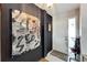 Modern entryway with a large abstract painting and tiled floor at 2407 Locksley St # 224, Sun City Center, FL 33573