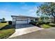Bright and airy home exterior with a two-car garage and landscaped front yard at 2407 Locksley St # 224, Sun City Center, FL 33573