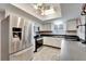 Modern kitchen with stainless steel appliances and white cabinets at 2407 Locksley St # 224, Sun City Center, FL 33573