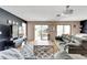 Bright living room with hardwood floors, comfortable seating and access to a patio at 2407 Locksley St # 224, Sun City Center, FL 33573