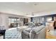 Spacious living area featuring hardwood floors, comfy sofas, and access to a patio at 2407 Locksley St # 224, Sun City Center, FL 33573