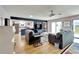 Spacious living room with hardwood floors, comfy sofas, and a view of the kitchen at 2407 Locksley St # 224, Sun City Center, FL 33573