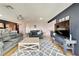 Bright living room with hardwood floors, comfy sofas, and a large TV at 2407 Locksley St # 224, Sun City Center, FL 33573