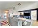 Open living room with hardwood floors, comfy sofas, and access to a patio at 2407 Locksley St # 224, Sun City Center, FL 33573