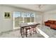 Bright sunroom features tiled floors, sliding doors, and a rustic wooden table with stools at 2407 Locksley St # 224, Sun City Center, FL 33573