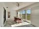 Sunroom with tiled floor, sliding glass doors, and a wooden table with stools at 2407 Locksley St # 224, Sun City Center, FL 33573
