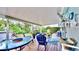 Relaxing back patio with covered seating area, outdoor rug, and lush landscaping at 2575 Shenandoah St, North Port, FL 34287