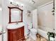 Clean bathroom with a tub, toilet, and a vanity with a mirror at 2575 Shenandoah St, North Port, FL 34287