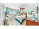 Bright bedroom with tiled floors, ceiling fan, and ample closet space at 2575 Shenandoah St, North Port, FL 34287