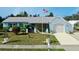 Cute light blue house with a white garage door, and nicely landscaped lawn at 2575 Shenandoah St, North Port, FL 34287