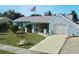 Light blue house with white garage door, American flag, and well-maintained lawn at 2575 Shenandoah St, North Port, FL 34287