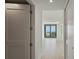 Long hallway with doors leading to rooms and a view of the living room at 301 1St S St # 205, St Petersburg, FL 33701