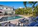 Inviting backyard oasis featuring a refreshing pool, patio furniture, and lush landscaping at 3953 Arkansas Ave Ne, St Petersburg, FL 33703