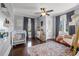 Charming bedroom with hardwood floors, window seating, and a crib at 3953 Arkansas Ave Ne, St Petersburg, FL 33703